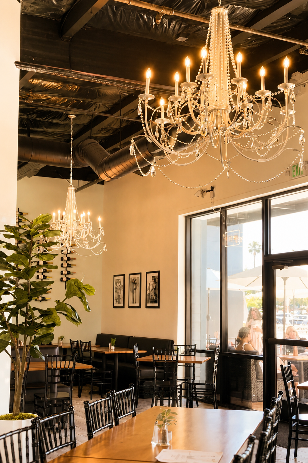 Crystal chandeliers against the blacked-out industrial ceiling