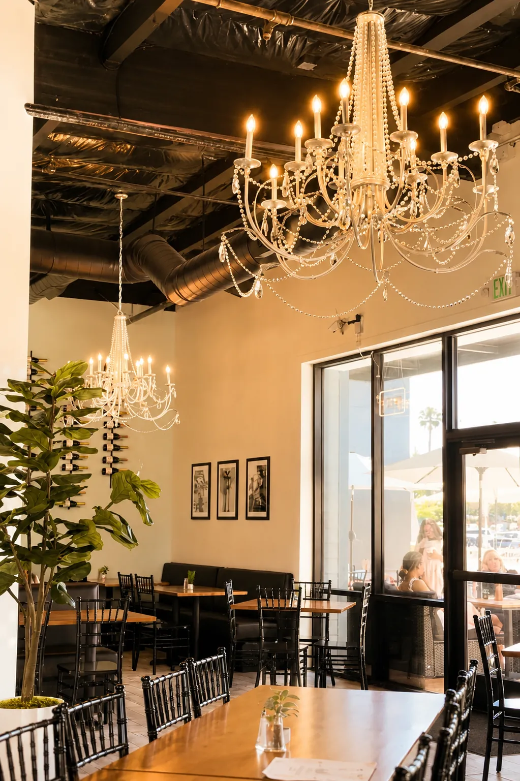 Crystal chandeliers against the blacked-out industrial ceiling